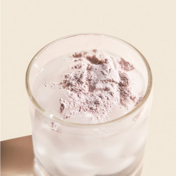 glass of water with powder on top glass of water with powder on top
