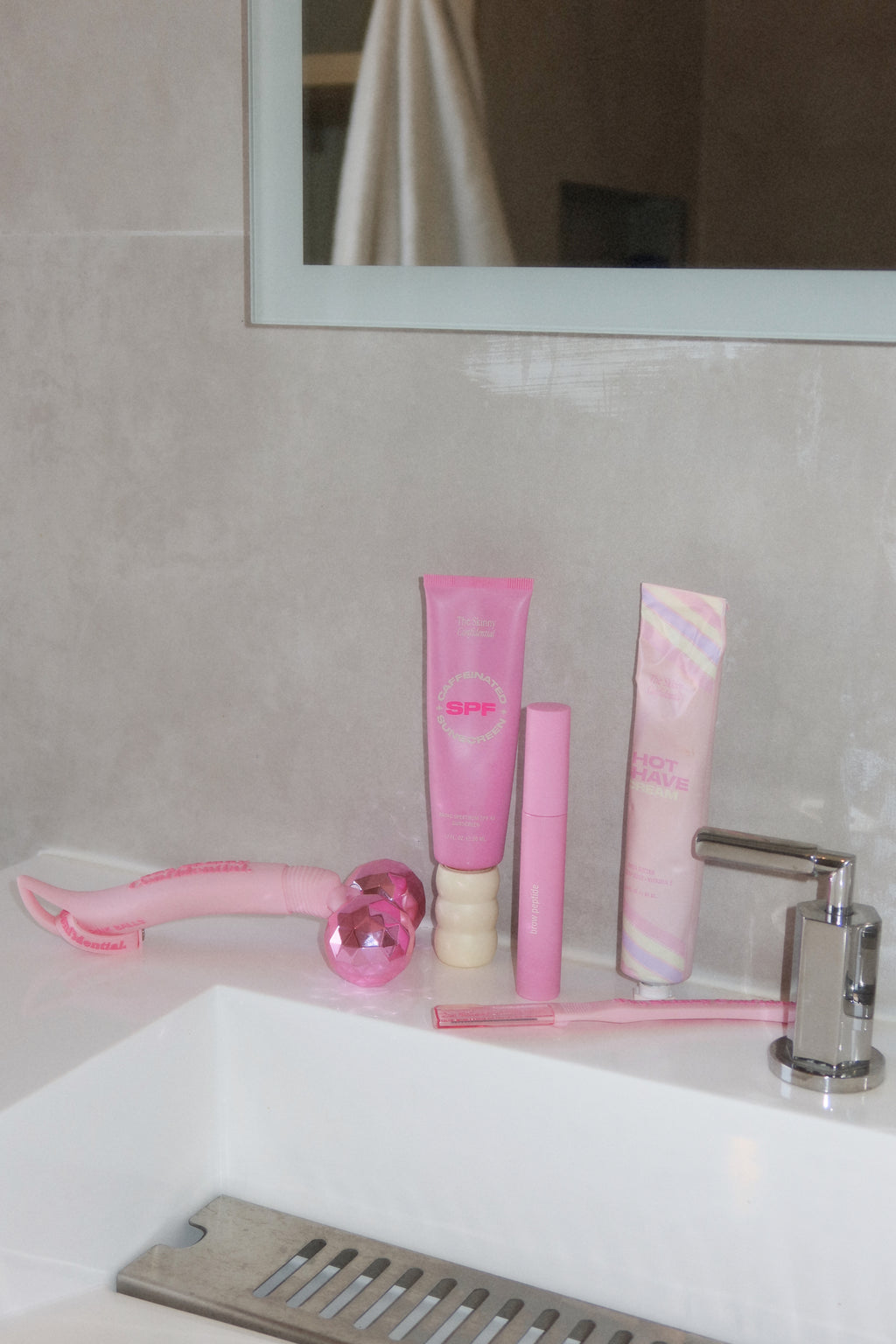 pink skincare products on bathroom counter pink skincare products on bathroom counter