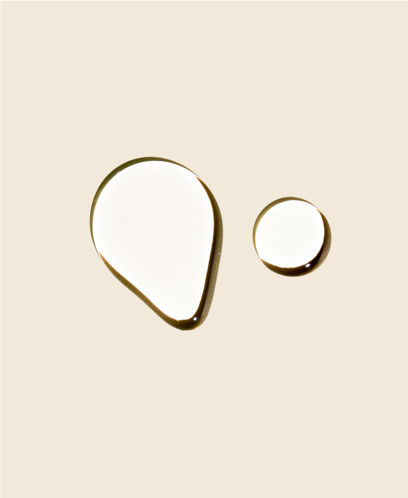 Oil drops on beige background.