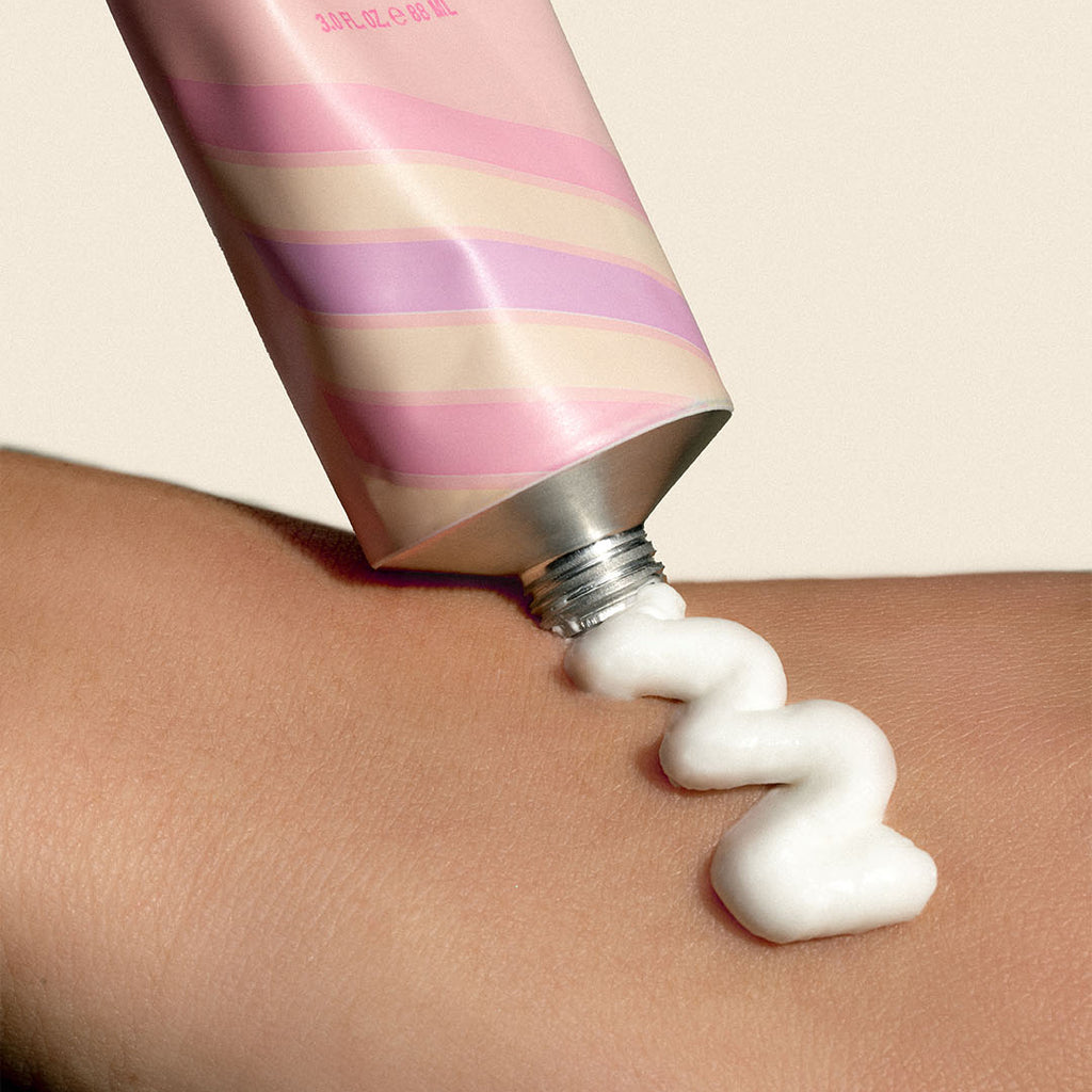Cream being applied from pink tube onto skin. Cream being applied from pink tube onto skin.