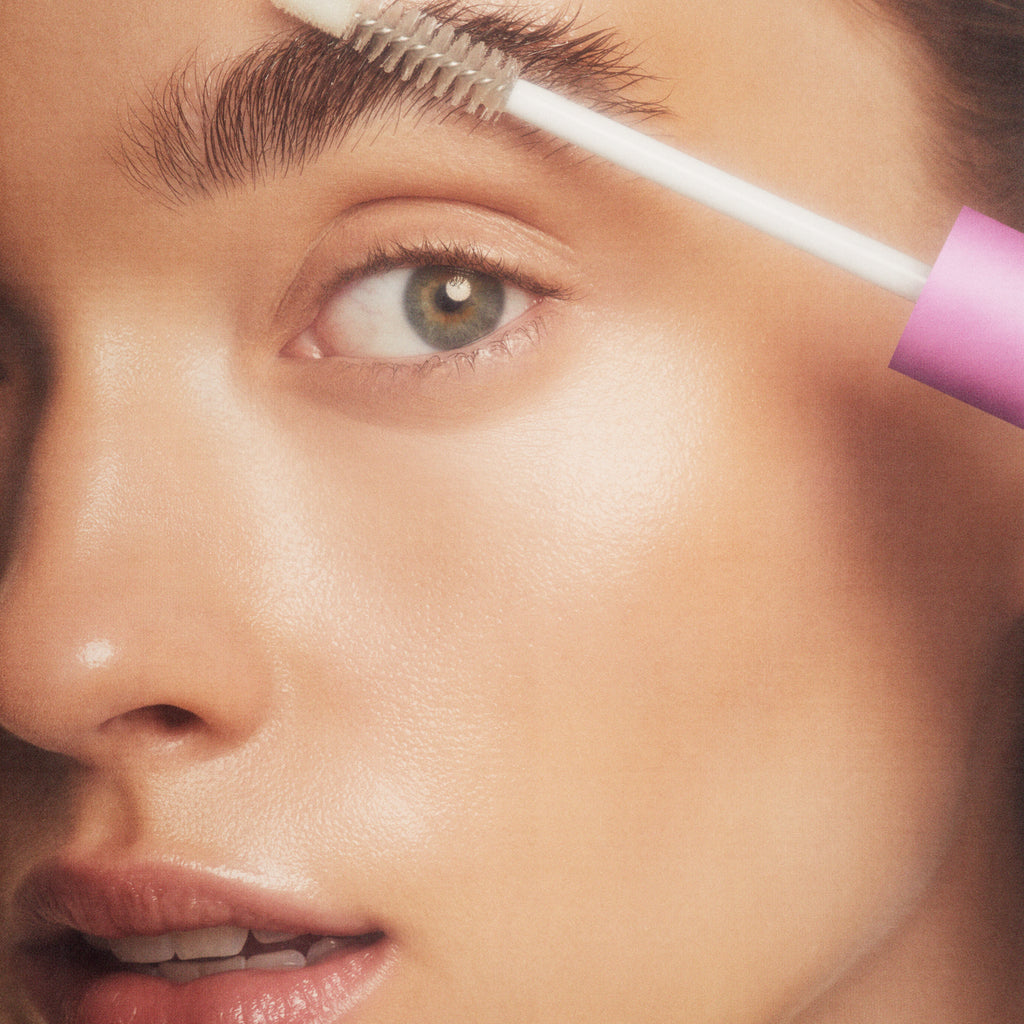 person applying eyebrow gel closeup person applying eyebrow gel closeup